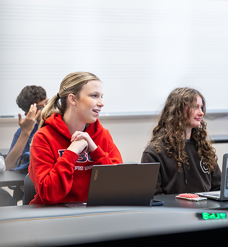 Summer Institute classroom picture of a girl wearing a red sweatshirt 