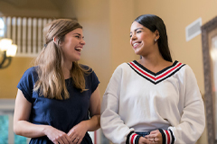 picture of two girls laughing and smiling 