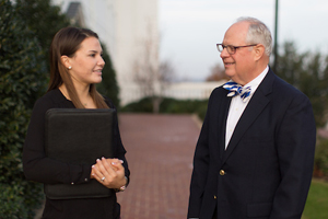 picture of a man and a woman speaking to each other in front of the chapel